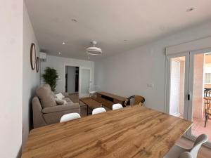 a living room with a wooden table and a couch at A&N Seafront 2 Torre del Mar in Torre del Mar +22 photos