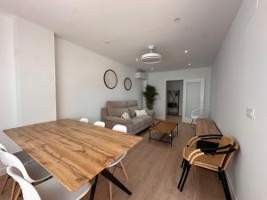 a living room with a wooden table and a couch at A&N Seafront 2 Torre del Mar in Torre del Mar