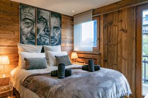 a bedroom with a large bed with a large painting on the wall at Arly in Megève
