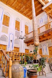 a room with a staircase and a wooden ceiling at Boutique Old City in Bukhara
