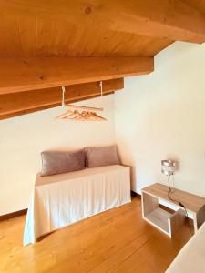 a bed in a room with a wooden ceiling at Gritti Palace Morcote - Vaniglia in Morcote +53 photos