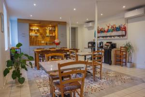 a dining room with a table and wooden chairs at Clos Ceres in Viré