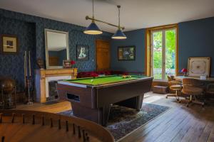 a living room with a pool table in it at Clos Ceres in Viré