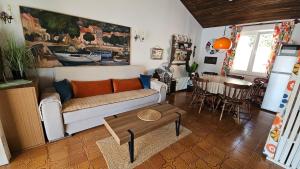 a living room with a couch and a table at Amasing view from the White terrase in Baška