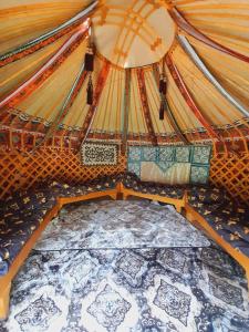 an inside of a yurt with a bed in it at Горное гнездо и юрты in Mineralʼnyy Istochnik Altyn-Arasan