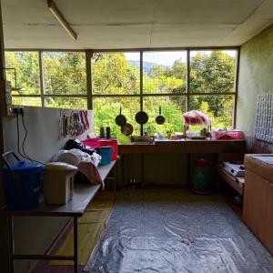 a kitchen with a counter and a window in a room at Kinabalu Poring Vacation Lodge in Kampung Poring