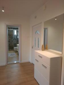 a white bathroom with a mirror and a sink at Sunrise Apartment in Igalo +37 photos