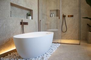 a bath tub in a bathroom with rocks at B&B Villa Margherita - Luxury Rooms in Padua in Padova