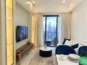 a living room with a couch and a large window at Chevalra Luxury TRI-ZEN Apartment in Central Colombo - Galle-Face & Lotus Tower View in Colombo