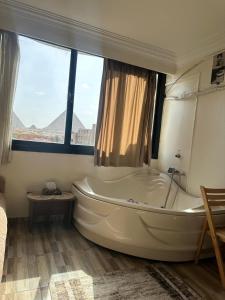 A bed or beds in a room at giza pyramids view