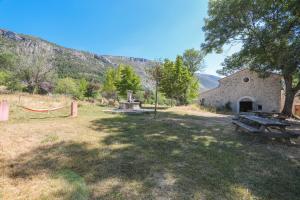 a picnic table in a field next to a building at Roulotte Ferme Saint-Pierre in Bargème +16 photos