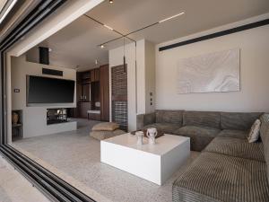 a living room with a couch and a coffee table at Villa Portokalea in Maleme
