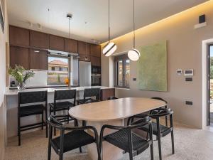 a kitchen and dining room with a table and chairs at Villa Portokalea in Maleme