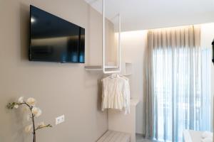 a living room with a tv on the wall at Ammos Korali in Olympiaki Akti