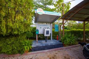 a gas pump at a gas station with a sign at Alaya Stays Jeevantara by ELIVAAS in Udaipur +115 photos