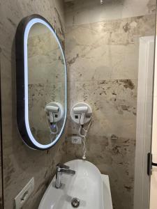 a bathroom with a mirror and a sink at Maper in Pogradec