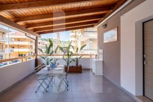 a patio with a table and chairs on a balcony at Homiday - Residence Venere in Alba Adriatica
