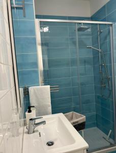 a bathroom with a sink and a glass shower at Appartamenti Sant'Angelo in Rossano Stazione +21 photos