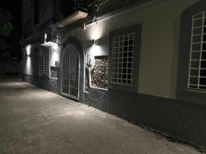 a cat standing in the doorway of a building at night at Appartamenti Sant'Angelo in Rossano Stazione