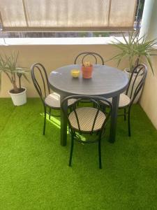 a table with two chairs and a table with green grass at Jardin secret in Antibes +8 photos