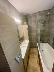 a bathroom with a tub and a sink and a shower at Jardin secret in Antibes
