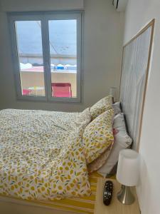 a bedroom with a bed with a view of the beach at Jardin secret in Antibes