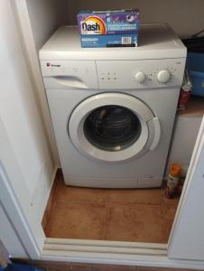 a washing machine with a box on top of it at Da Massimo in Cefalù