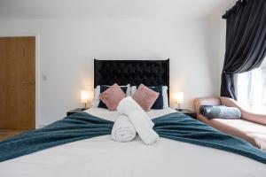 a bedroom with a large white bed with pillows at Stylish 2-Bed Apartment in Manchester City Centre in Manchester