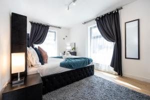 a bedroom with a bed with a large window at Stylish 2-Bed Apartment in Manchester City Centre in Manchester