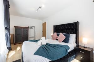 a bedroom with a large bed with two towels on it at Stylish 2-Bed Apartment in Manchester City Centre in Manchester