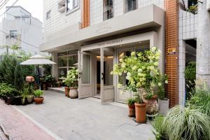 a entrance to a building with potted plants on the sidewalk at Stay Dooroo in Suncheon