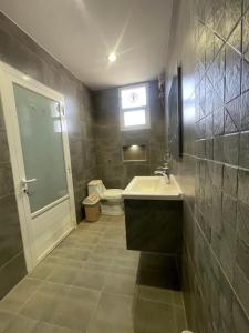a bathroom with a sink and a toilet at شقة بالدور الثالث in Quai +5 photos