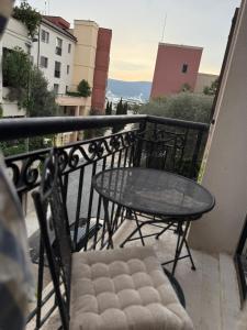 a table and chairs on a balcony with a view at Porto Marina Residence in Tivat