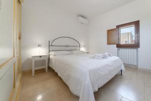 A bed or beds in a room at Masseria Galatea Agriturismo