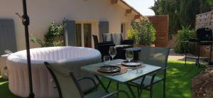 a table with two glasses of wine on a patio at Les Baraquettes de St clair in Sète