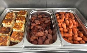 four trays filled with different types of food at Aliston Hotel Thassos in Skala Potamias