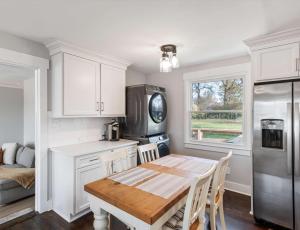 a kitchen with a dining room table and a refrigerator at Franklin Retreat - Sleeps 4 in Franklin