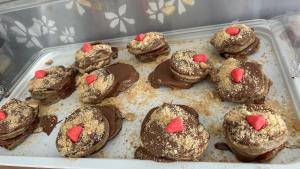 a tray of chocolate cookies with hearts on them at Aliston Hotel Thassos in Skala Potamias