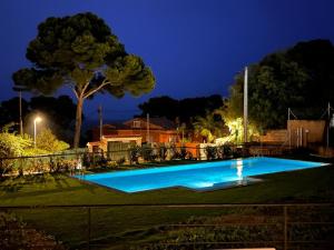 a swimming pool in a yard at night at Bonavista Begur in Begur