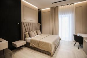 a bedroom with a bed and a large window at LUNA Gallery Suites in Naples