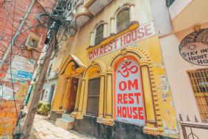 a building with a sign on the side of it at Om Rest House by Bunny Cafe Varanasi in Varanasi