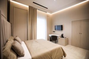 a hotel room with a bed and a desk at LUNA Gallery Suites in Naples