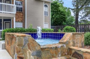 a water fountain in front of a house at The Davis 1824 I Spacious 2 Bed 2 Bath in Huntsville
