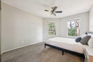 a bedroom with a bed and a ceiling fan at The Davis 1824 I Spacious 2 Bed 2 Bath in Huntsville +15 photos
