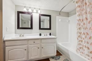 a bathroom with two sinks and a bath tub at The Davis 717 I Comfy And Spacious 1 Bed 1 Bath in Huntsville