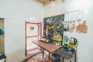 a room with a wooden table and a window at Om Rest House by Bunny Cafe Varanasi in Varanasi