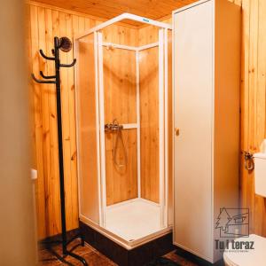 a shower with a glass door in a bathroom at Tu i teraz- Domek wypoczynkowy in Kamienica Królewska +30 photos