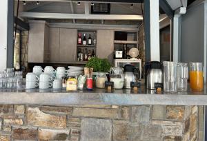 a bar with a counter with drinks and other items at Aliston Hotel Thassos in Skala Potamias