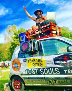 a man sitting on top of a car at Løst Souls Oktoberfest Campsite basic package in Munich