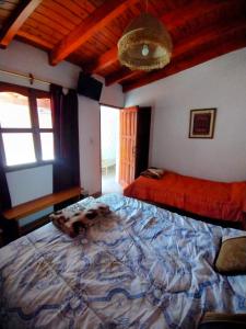 a bedroom with a large bed and a large window at El mirador de iruya in Iruya +19 photos